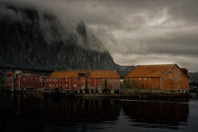 Scenic view of lake by mountain against sky