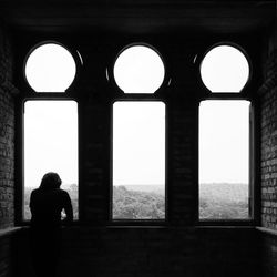 Woman standing in tunnel