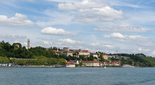 Scenic view of sea by buildings against sky