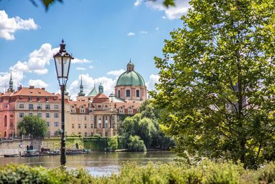 View of buildings by river in city