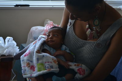 Close-up of friends sitting on floor