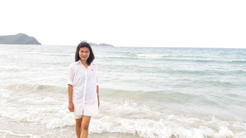 Portrait of woman standing on beach