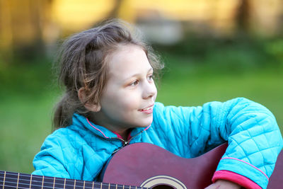 Portrait of girl sitting in park