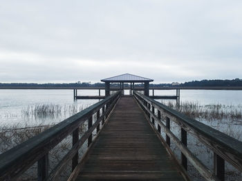 Pier over lake against sky