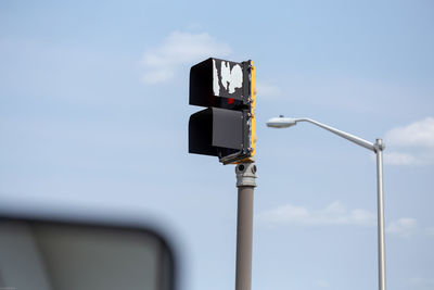 Low angle view of road signal against sky