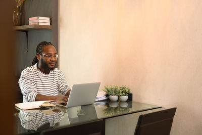 Young woman using laptop at office