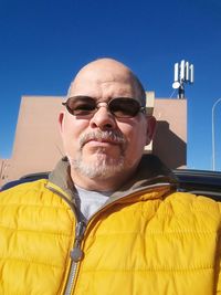 Portrait of man wearing sunglasses against clear sky
