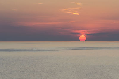 Scenic view of sea against orange sky