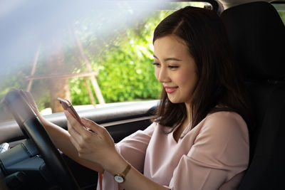 Beautiful woman sitting in car