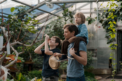 Adventurous family inspecting tropical gallery in botanical garden. local travel