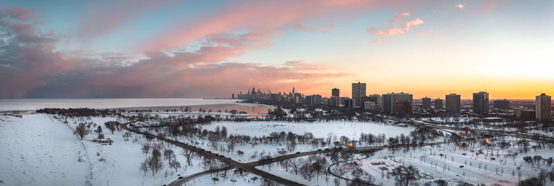 Beautiful chicago winter skyline aerial panorama above a snow covered landscape at sunset.