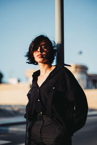 Portrait of woman standing against sky