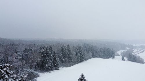 Scenic view of snow covered land against sky