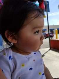 Close-up portrait of cute girl looking away