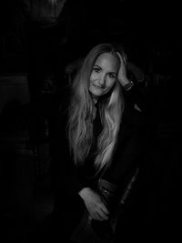 Portrait of woman standing against wall