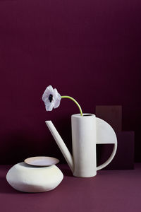 Modern vase, flower on burgundy felt background