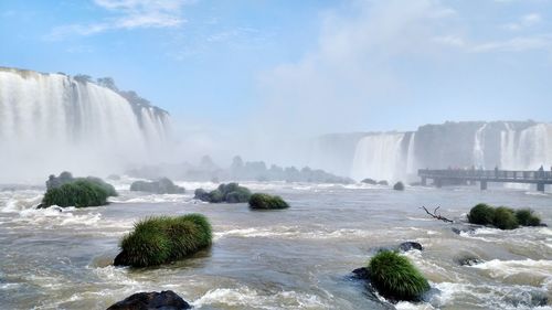 Scenic view of waterfall against sky