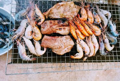 High angle view of meat on barbecue grill