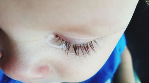 Close-up of baby boy crying while looking down