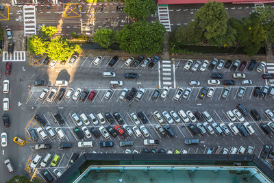 High angle view of cars on road by buildings in city