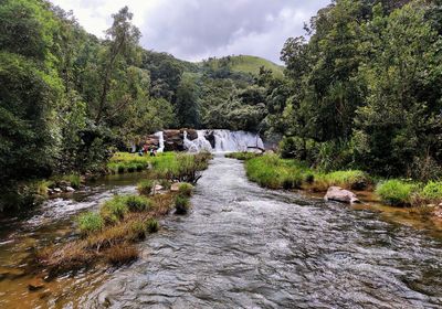 Scenic view of river amidst mountains against sky