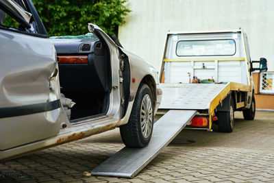 Crashed car loading into tow truck after traffic accident on road