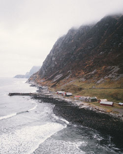 Scenic view of sea and mountains against sky