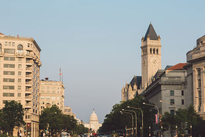 Buildings in city against clear sky