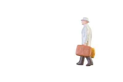 Man wearing hat standing against white background