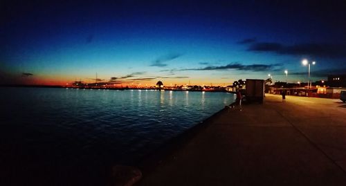 Pier in sea at dusk