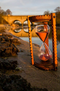 Close-up of hourglass on field