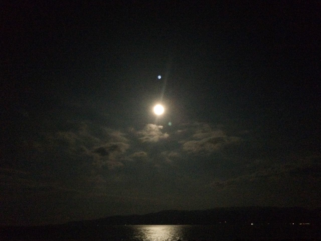 scenics, tranquility, tranquil scene, beauty in nature, night, sky, moon, nature, idyllic, water, astronomy, dark, waterfront, majestic, low angle view, copy space, illuminated, reflection, cloud - sky, outdoors