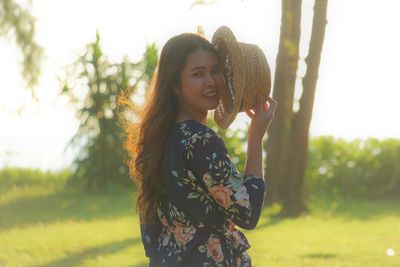 Portrait of woman standing against plants