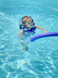 High angle view of boy swimming in pool