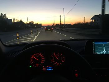 Cars on road against sky seen through car windshield