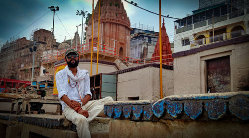 Man against buildings in city