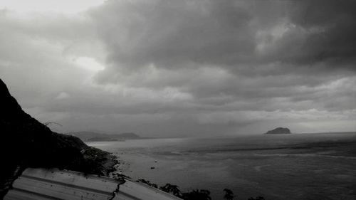 Scenic view of sea against cloudy sky