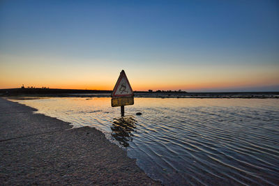 Scenic view of sea against clear sky during sunset