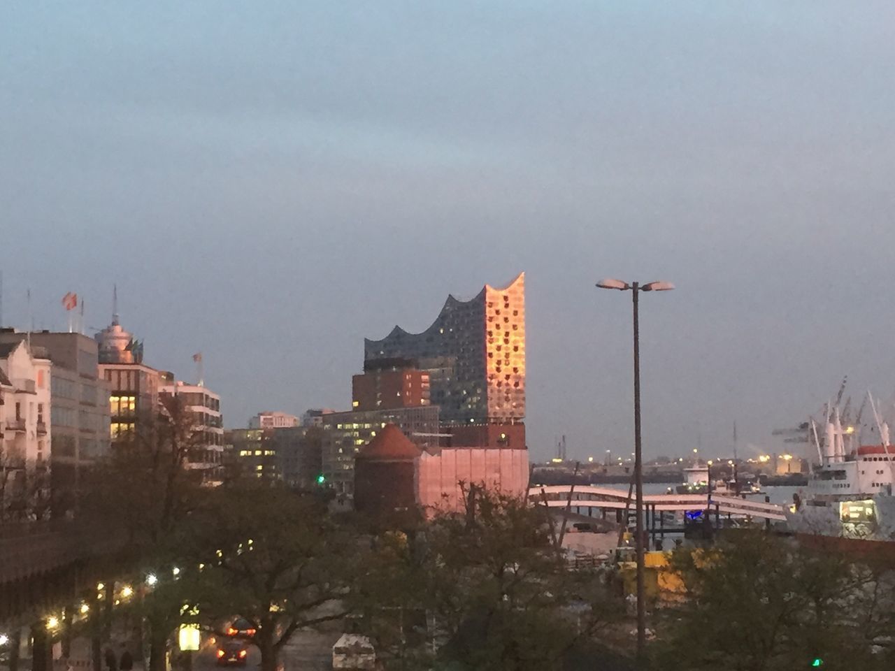 ILLUMINATED BUILDINGS AGAINST SKY AT DUSK