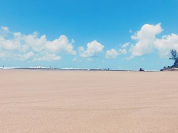 Scenic view of beach against blue sky