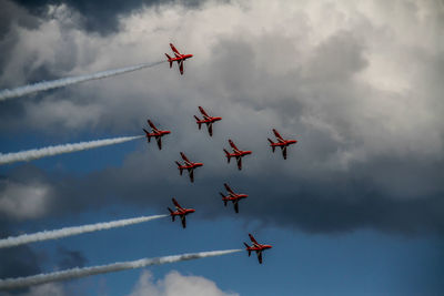 Low angle view of airshow against sky