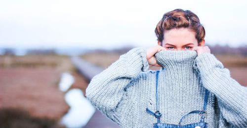Portrait of teenage girl standing on land