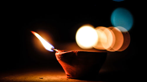 Close-up of lit diya at night