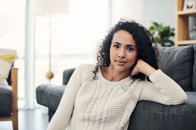 Portrait of woman sitting at home