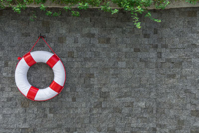 Rescue buoy hanging on the wall with copy space