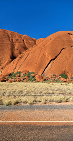 Scenic view of desert against clear blue sky