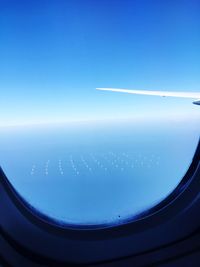 Cropped image of airplane wing over landscape