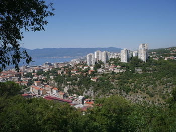 Buildings in city against clear sky