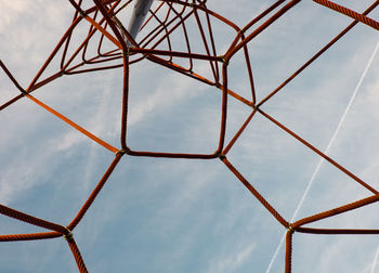 Low angle view of sky seen through ropes