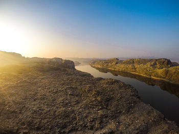 Scenic view of landscape against clear sky during sunset